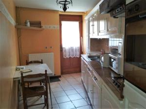 a kitchen with a counter and a table in it at Beau repaire in Remilly-Aillicourt