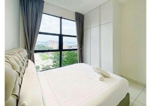 a bedroom with a bed and a large window at Arte Mont Kiara By The Relax Stay Kualalumpur in Kuala Lumpur