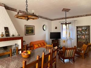 a living room with a table and chairs and a television at Casa Graziana in Terni
