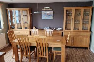 a dining room with a wooden table and chairs at Unique 2BD Apartment Folkestone Harbour in Kent