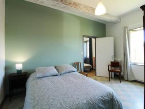 a bedroom with a bed and a blue wall at Agréable maison de campagne 12 voyageurs in Germagny
