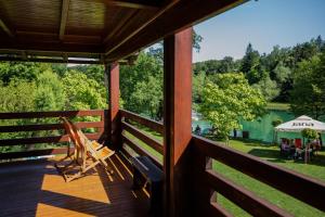 a view from the porch of a cabin with a view of the lake at Apartment Mrežnička kuća in Duga Resa