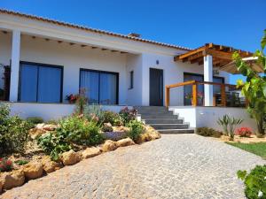 a house with a pathway in front of it at Casa Monte Salema in Vila do Bispo