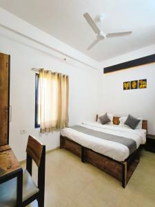 a bedroom with a bed and a ceiling fan at White Town By Ashoka Group in Udaipur