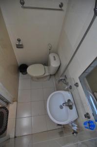a bathroom with a toilet and a sink at Bluebell Hotel in Hanoi