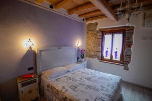 Postel nebo postele na pokoji v ubytování B&B il mio Casale