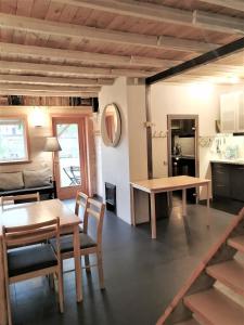 a kitchen and dining room with a table and chairs at Beltes Guest House in Jūrmala