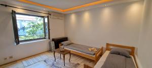 a bedroom with two beds and a window at Quiet place near the city center in Sajmište