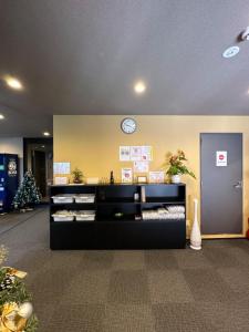 a waiting room with a clock on a wall at Miro京都二条城ホテル in Kyoto