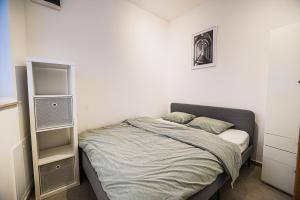 a bedroom with a bed with a speaker on it at Apartment Trg in Brežice