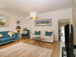 a living room with a couch and a table at 24 Bridge Street in Banff