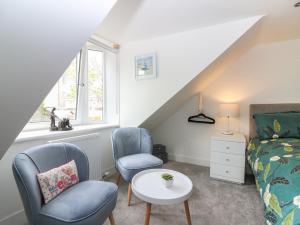 a bedroom with two chairs and a bed and a table at 24 Bridge Street in Banff