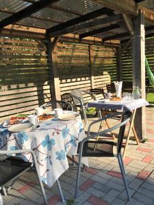 two tables and chairs with plates of food on them at Beltes Guest House in Jūrmala