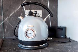 a tea kettle sitting on top of a counter at Pass the Keys Modern 3 Bed Flat on the Historic Royal Mile in Edinburgh