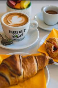 a cup of coffee and a pastry on a table at Le Scale di Pietra in Conversano