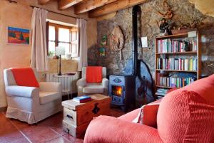 a living room with a couch and a wood stove at El Pedrueco turismo rural in Nava