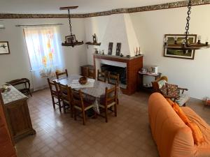 a living room with a table and a fireplace at Casa Graziana in Terni +16 photos