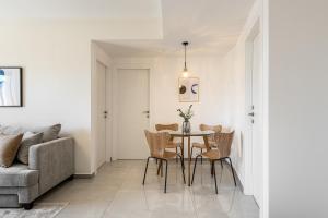 a dining room with a table and chairs and a couch at MACHNE YEHUDA - Exclusive Collection - By HOMY in Jerusalem +21 photos