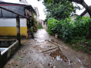 an alley in a house with water on the ground at Home stay jaya pribadi By 29 