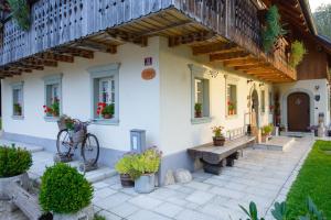 a house with a bike parked in front of it at Rustic House 13 in Bohinj