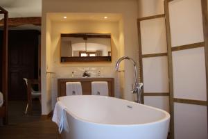 eine Badewanne in einem Badezimmer mit Küche in der Unterkunft Cottage - La Maison du Château - By DOMAINE RIBERACH in Bélesta