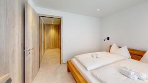 Voodi või voodid majutusasutuse Family Holiday Apartment Krone Churwalden toas