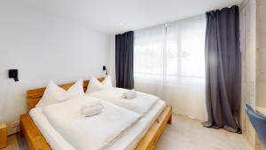 Voodi või voodid majutusasutuse Family Holiday Apartment Krone Churwalden toas