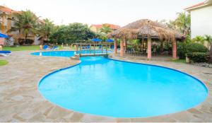 a pool at a resort with blue water at Ocean Dream 1st See Line Studio in Cabarete