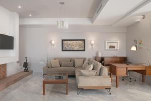 a living room with a couch and a table at Macaris Suites & Spa in Rethymno Town