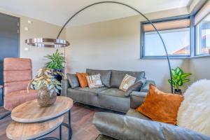 a living room with a couch and a table at Natuurvilla 18 Waswaal in De Waal