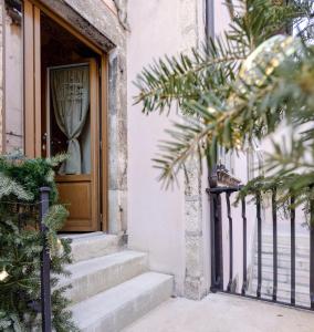 eine Eingangstür eines Hauses mit Treppen und Bäumen in der Unterkunft Le dimore nel borgo in Pescocostanzo