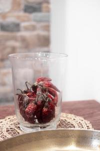 a glass bowl of raspberries sitting on a table at Лиловата Къща in Kalofer