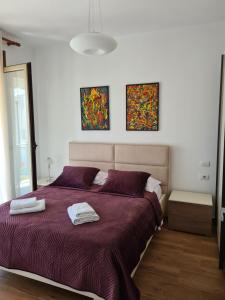 a bedroom with a bed with two towels on it at Vacation House in Draç +23 photos