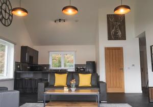 a living room with a couch and a table at Shoreland Lodges - Holly Lodge in Fort Augustus