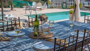 - une table avec une bouteille de vin et des verres à côté de la piscine dans l'établissement Casa Campo de Ita by Ruralidays, à Torrox