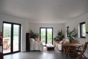 a living room with two couches and a table at Casa do Rio in Treixedo