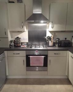 a kitchen with a stove top oven in a kitchen at Immaculate 2-Bed Apartment in Bury in Bury