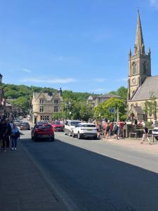 a city street with a clock tower and a church at Immaculate 2-Bed Apartment in Bury in Bury