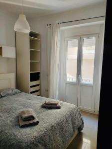 een slaapkamer met een bed met twee handdoeken erop bij Apartamento Feduchy in Cádiz