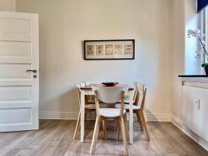 a dining room with a table and chairs at Three Bedroom Apartment In Valby, Valby Langgade 214, in Copenhagen