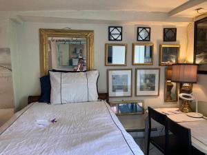 a bedroom with a bed and a table and mirrors at Highland Park Pittsburgh in Pittsburgh