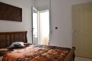 a bedroom with a bed and a large window at Your Sweet Appartment in Fez