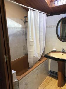 a bathroom with a tub and a sink and a shower at La ferte 
