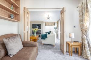 a living room with a couch and a chair at Stewarts Resort Lodge 76 in St Andrews