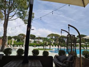 a swing at a resort with a swimming pool at Vacation House in Draç