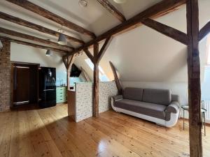 a living room with a couch and wooden floors at Hotel Katrina in Cēsis