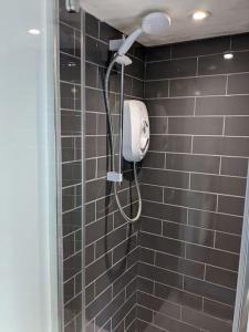 een douche met een douchekop in de badkamer bij Cosy character cottage in central Marlborough UK in Marlborough