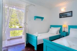 two beds in a room with a window at Stiniva Bay - Hvar Villa in Brusje