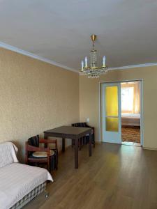 a living room with a table and chairs and a bed at Апартаменты Инал-ипа 10 in Sukhum