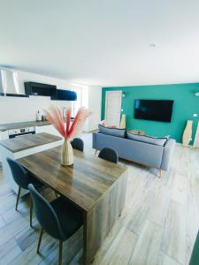 a living room with a table and a couch at Gte du moulin brochat avec espace jacuzzi commun in Saint-Jean-de-Vaux +16 photos